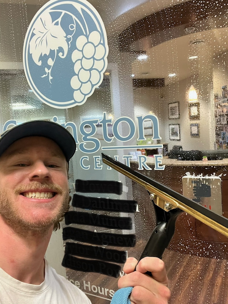 Kelowna Cleaners owner cleaning commercial windows